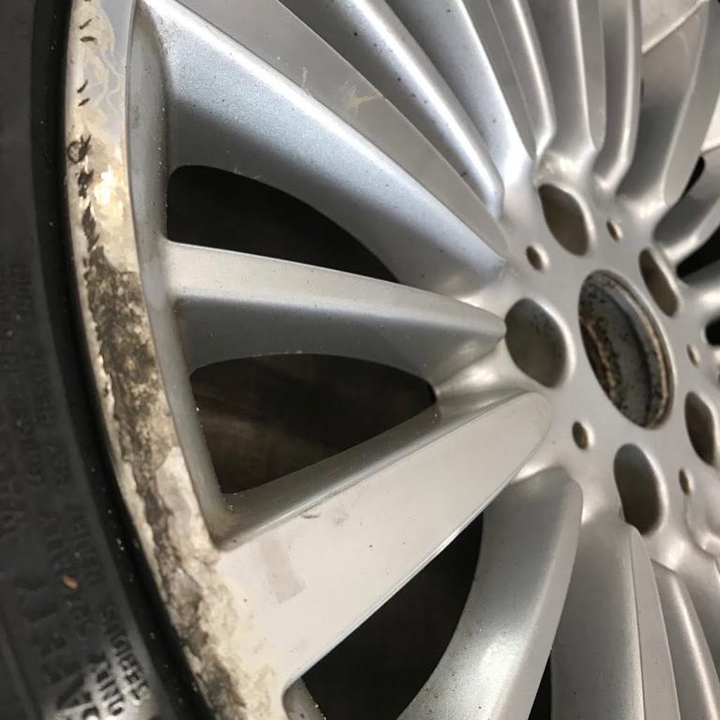Corroded and pitted alloy wheel face before refurbishment